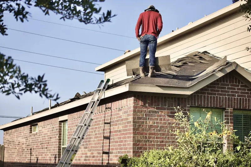 Professional roofer working on a residential roof in Talbert